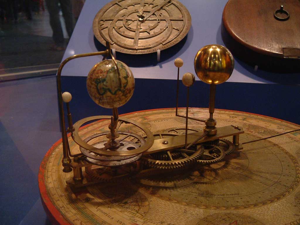 A small orrery, a physical model, showing earth and the inner planets is shown.