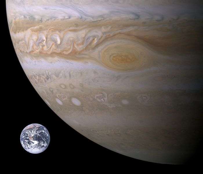 The Earth is shown next to a portion of Jupiter with the Great Red Spot being larger in size than Earth.
