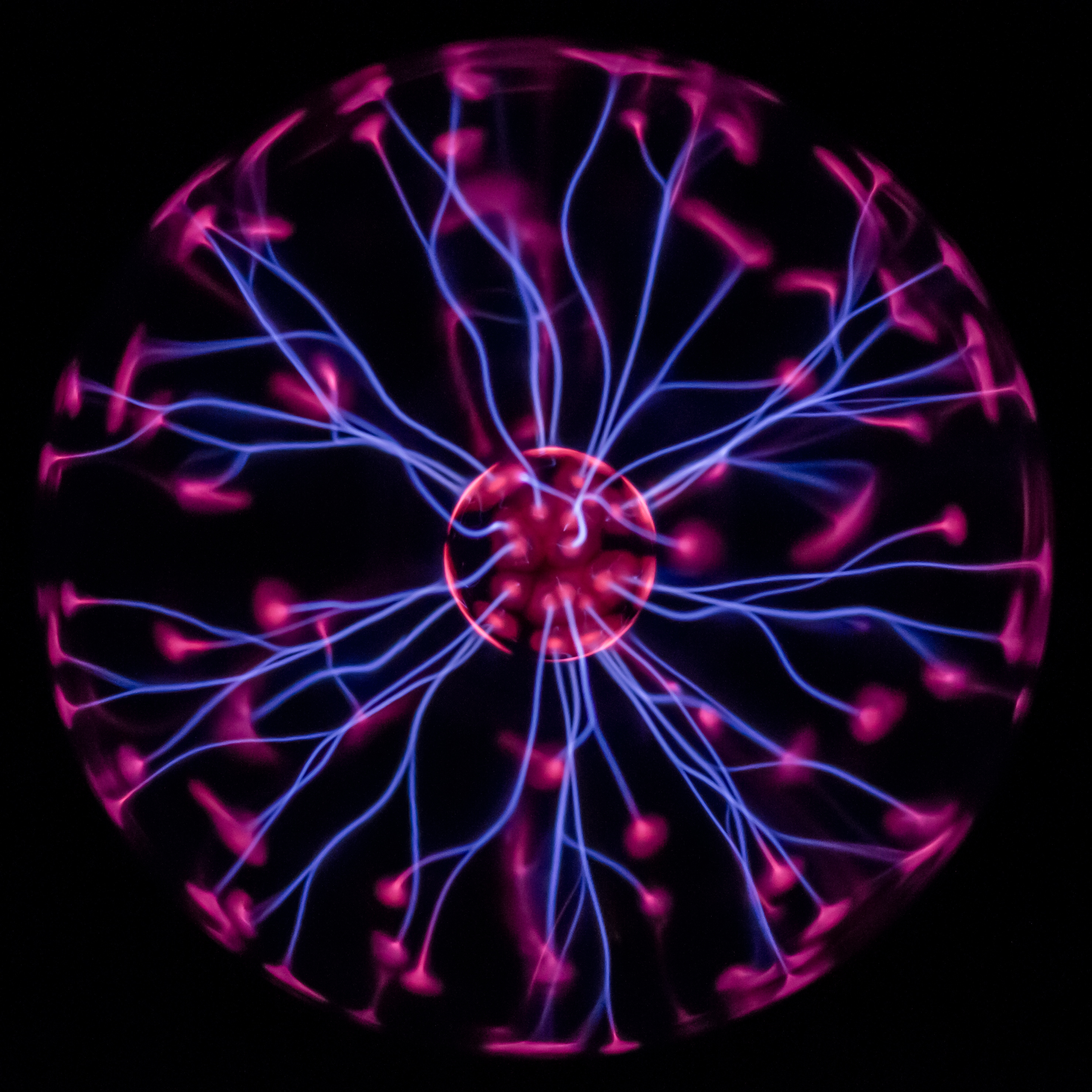 A plasma globe produces a plasma, fluid of charged particles. https:/commons.wikimedia.org/wiki/File:Plasma_globe_60th.jpg; 