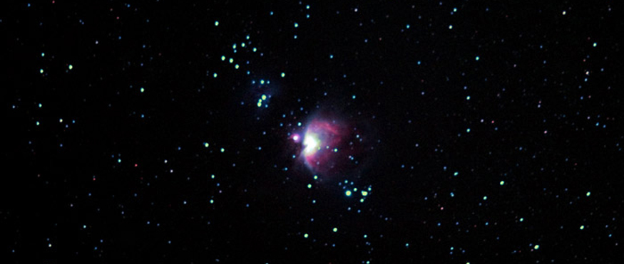 Céu noturno com o brilhante aglomerado da Nebulosa de Orion no centro entre o grupo de estrelas.