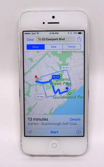 A photograph of an Apple iPhone showing directions on a map.