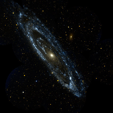 Image of Andromeda Galaxy in Visible Light. The wisps of blue making up the galaxy's spiral arms are neighborhoods that harbor hot, young, massive stars. Meanwhile, the central orange-white ball reveals a congregation of cooler, old stars that formed long ago.