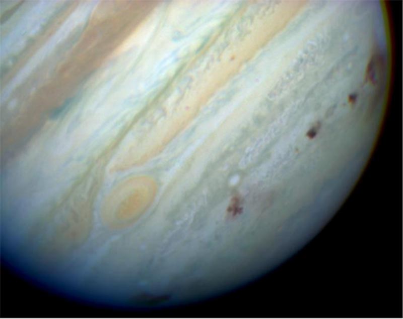 Image of Jupiter exhibiting some of the Shoemaker–Levy 9 fragment impact sites as black spots.