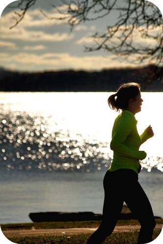 Long distance runners, such as this woman running by the lake, try to keep constant velocity