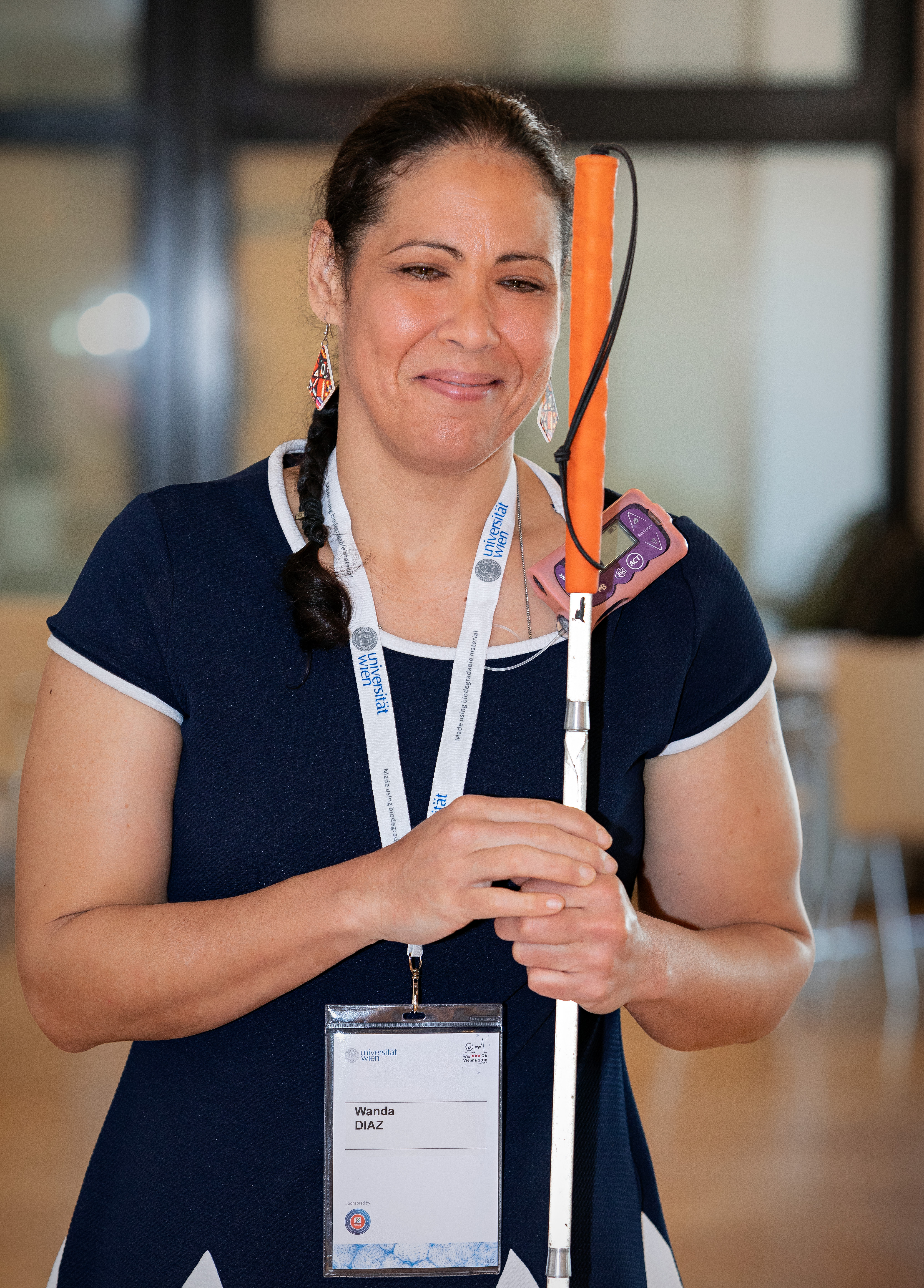 Dr. Wanda Diaz-Merced shown smiling and dressed in a business casual style of dress