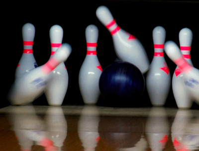 A bowling ball, just as it is striking the pins.