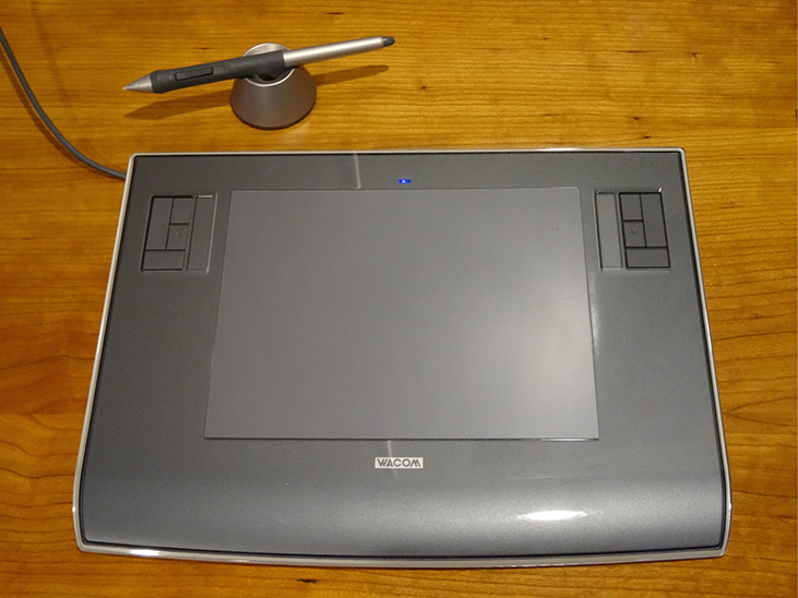 Photograph shows a digital tablet with a stylus.