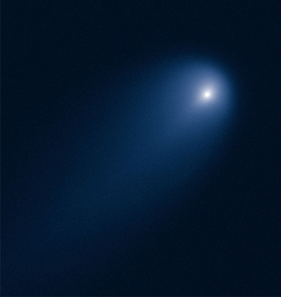 A Hubble Telescope photo of a comet. It appears as a bright dot with fuzzy light around it.