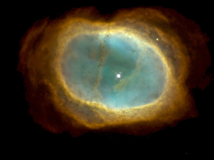Uma bolha esverdeada é vista contra um fundo preto. As bordas são amareladas. Uma estrela branca brilhante é vista dentro dela.