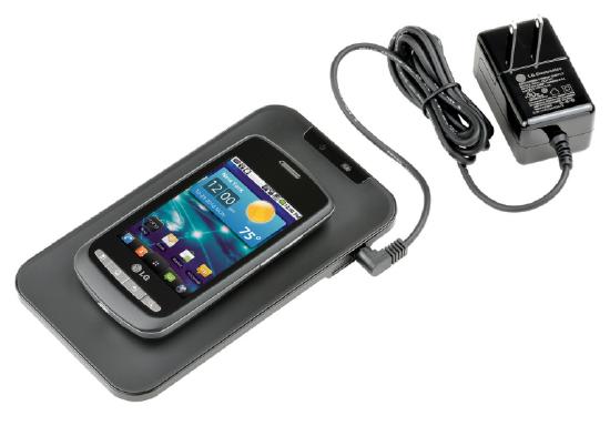 Photograph of a mobile phone on top of a mat connected to a charger.